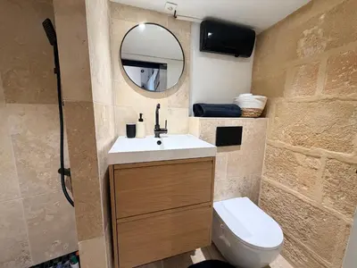 a kitchen with white cabinets and a counter top at Aix-en-Provence - studio plein centre ville refait à neuf avec climatisation in Aix-en-Provence
