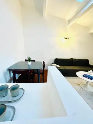 a living room with a table and a couch at Rare duplex with rooftop terrace in Aix-en-Provence