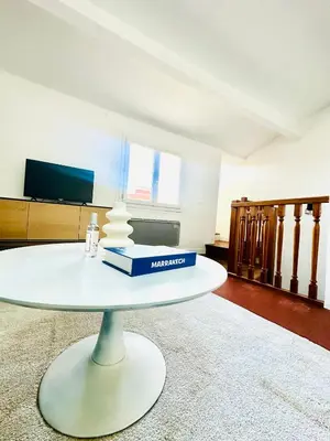 a white table with a box on it in a room at Rare duplex with rooftop terrace in Aix-en-Provence