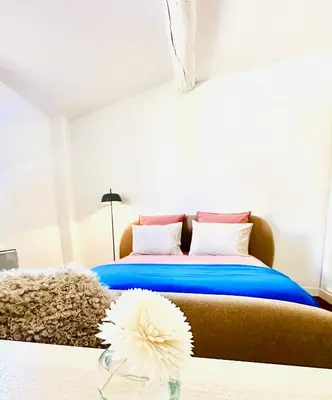 a bedroom with a bed and a flower on a table at Rare duplex with rooftop terrace in Aix-en-Provence