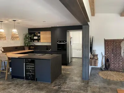 a kitchen with black cabinets and a counter top at Villa Luxury Lagoon - Aix en Provence in Ventabren