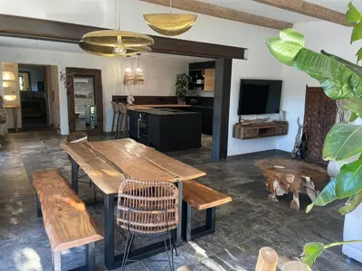 a dining room with a wooden table and chairs at Villa Luxury Lagoon - Aix en Provence in Ventabren