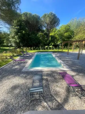 a swimming pool with a chair in the middle at 4-bedroom house with a pool in LʼIsle-sur-la-Sorgue