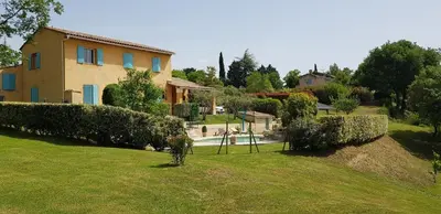 a house on a hill with a yard at Dépendance de charme avec piscine en luberon in Peypin-dʼAigues