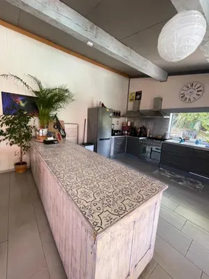 a large kitchen with a large island in the middle at Le Mas de la Butte Blanche in Orgon