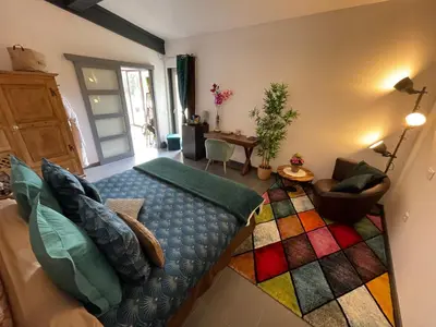 a bedroom with a large bed with a colorful rug at Le Mas de la Butte Blanche in Orgon