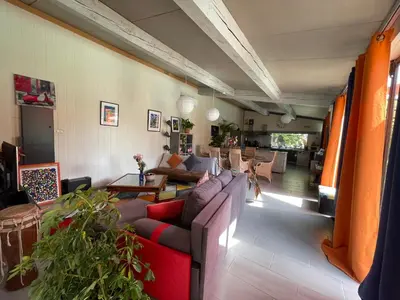 a living room with a couch and a table at Le Mas de la Butte Blanche in Orgon