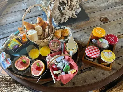 a table with a tray of food on a table at Le Mas de la Butte Blanche in Orgon