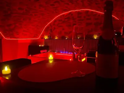 a red room with a table and a wine glass at Secret LoveRoom - SpaBalnéo, Lit King Size, CLIM, Chic, calme et discret, 2 personnes in Saint-Chamas