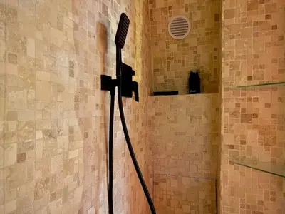 a shower with a blow dryer in a bathroom at Secret LoveRoom - SpaBalnéo, Lit King Size, CLIM, Chic, calme et discret, 2 personnes in Saint-Chamas