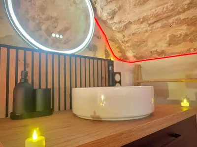 a table with two lit candles and a mirror at Secret LoveRoom - SpaBalnéo, Lit King Size, CLIM, Chic, calme et discret, 2 personnes in Saint-Chamas