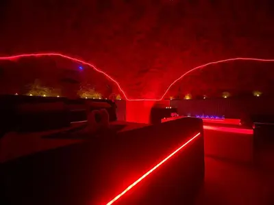 a red lighted room with red lights on a stage at Secret LoveRoom - SpaBalnéo, Lit King Size, CLIM, Chic, calme et discret, 2 personnes in Saint-Chamas