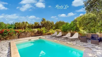 a swimming pool with lounge chairs and a fence at gite de charme au pied du luberon avec piscine privée à Apt en Provence in Apt