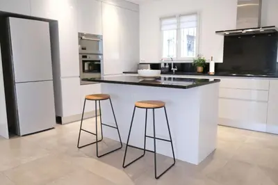 a kitchen with a counter and two stools at Holiday rental with pool in the Alpilles for 6 people in Plan-dʼOrgon