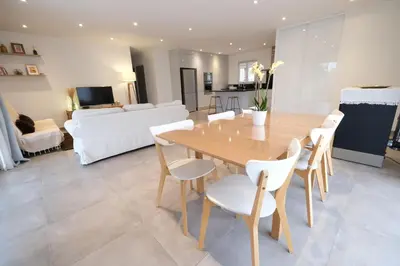 a dining room and living room with a wooden table and chairs at Holiday rental with pool in the Alpilles for 6 people in Plan-dʼOrgon