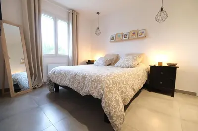 a bedroom with a bed and a large window at Holiday rental with pool in the Alpilles for 6 people in Plan-dʼOrgon