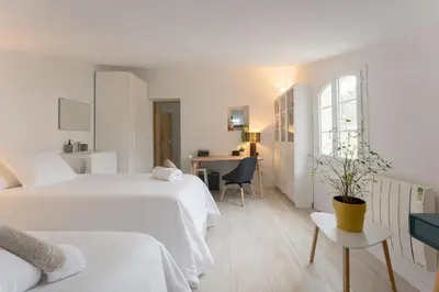 a white bedroom with two beds and a desk at Aurenza - Piscine - Jardin paysager - Vue campagne in Éguilles