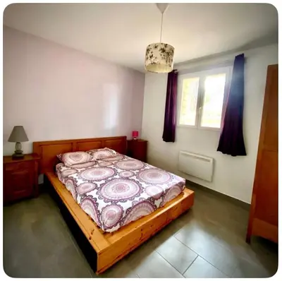 a bedroom with a bed and a window at Maison provençale in Céreste