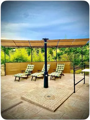 a patio with chairs and a gazebo at Maison provençale in Céreste