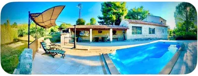 a house with a swimming pool in front of a house at Maison provençale in Céreste
