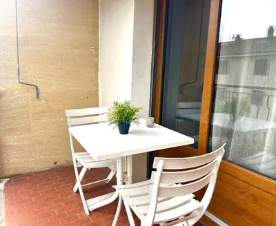 a white table and chairs with a potted plant on it at Superbe T4 proche Aix centre ville avec clim et parking in Aix-en-Provence