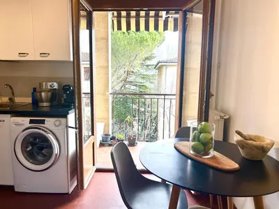 a small kitchen with a table and a washing machine at Superbe T4 proche Aix centre ville avec clim et parking in Aix-en-Provence