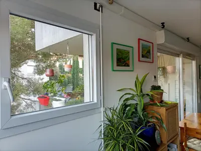 a window in a room with potted plants at T2 lumineux balcon, parking facile, climatisation, Wi-Fi in Aix-en-Provence