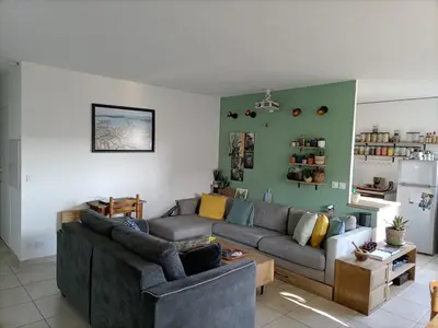 a living room with a couch and a table at T2 lumineux balcon, parking facile, climatisation, Wi-Fi in Aix-en-Provence