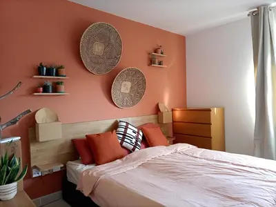 a bedroom with a bed and plates on the wall at T2 lumineux balcon, parking facile, climatisation, Wi-Fi in Aix-en-Provence