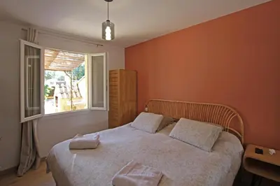 a bedroom with a bed with two pillows on it at Havre de paix avec piscine & spa - proche Ventoux in Saint-Didier
