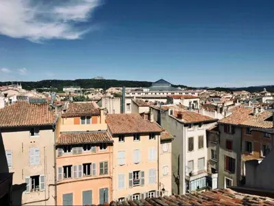 a patio with a couch and a table and a bench at Grand appartement avec terrasse place Richelme in Aix-en-Provence