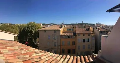 a patio with a table and chairs on a patio at Grand appartement avec terrasse place Richelme in Aix-en-Provence