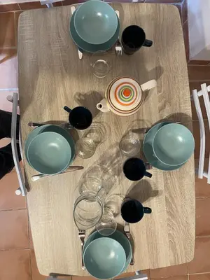 a table with bowls and plates on top of it at plaisir de vacances in Aix-en-Provence