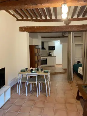 a kitchen and living room with a table and chairs at plaisir de vacances in Aix-en-Provence