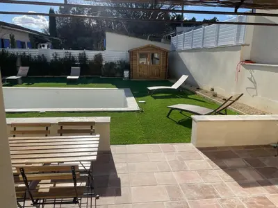 a backyard with chairs and a bench and a table at South Luberon residence in Pierrevert