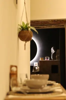 a wooden table with two bowls and a plant on it at Le Petit Provençal in Sénas