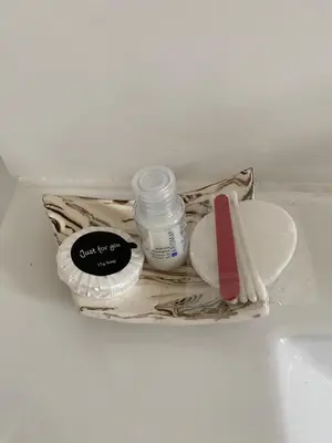a bag with a bottle of medicine and a spoon at La Cigale et la Fourmi in Les Taillades