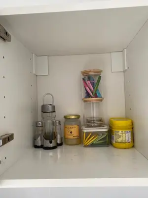 a shelf in a kitchen with various items on it at La Cigale et la Fourmi in Les Taillades