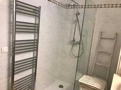 a bathroom with a shower with a glass door at Jolie maison avec piscine à Gordes in Gordes