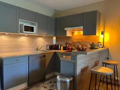 a kitchen with blue cabinets and a counter top at Jolie maison avec piscine à Gordes in Gordes