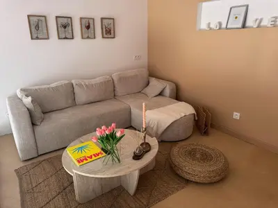 a living room with a couch and a table at COZY LOFT - Maisonnette esprit loft in Saint-Cannat