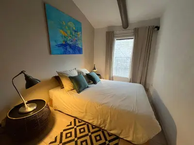 a bedroom with a bed and a window at La petite fontaine in Bédoin