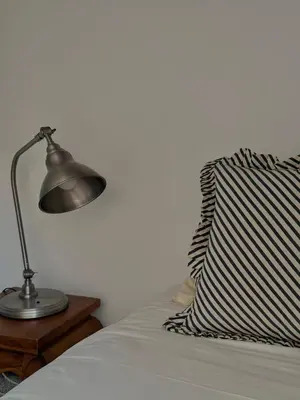 a bedroom with a bed and a large window at La petite fontaine in Bédoin