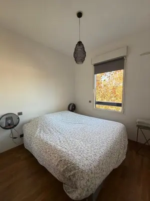 a bedroom with a bed and a window at La Rotonde in Aix-en-Provence