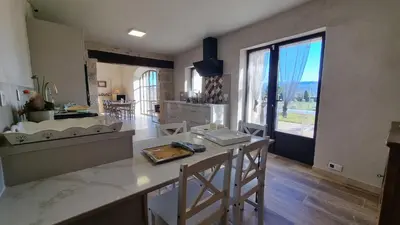 a kitchen with a counter and a large window at La Fabrique in Gargas