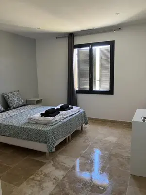 a bedroom with a bed and a window at Villa situé à Sainte-Tulle in Sainte-Tulle