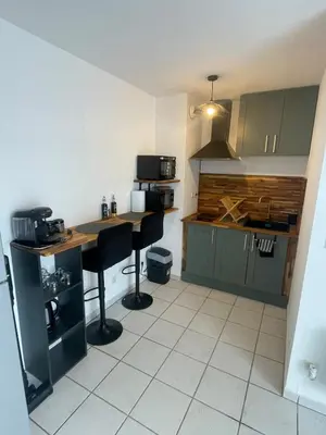 a bedroom with a bed and a refrigerator in it at Appartement en résidence privé Avignon Agroparc in Avignon
