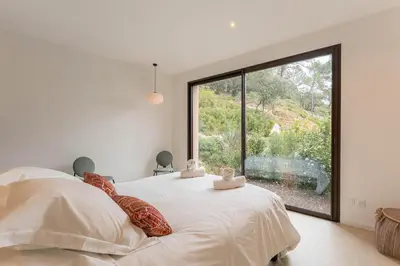 a bedroom with a bed with a large window at Elynéa - Vue panoramique - Haut standing - Piscine in Rognes