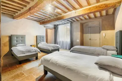 a bedroom with three beds in a room at La Bastide des Plâtrières in La Roque-sur-Pernes