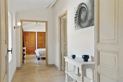 a hallway with a door leading to a bedroom at La Bastide des Plâtrières in La Roque-sur-Pernes